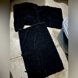 3 Black bathroom rugs. 2 are approximately 20”x30”, 1 Ushaped  contour rug.